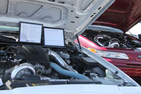 1992 Ford Crown Victoria - Two Ford Crown Victorias with hoods open, displaying their engines at a car show.