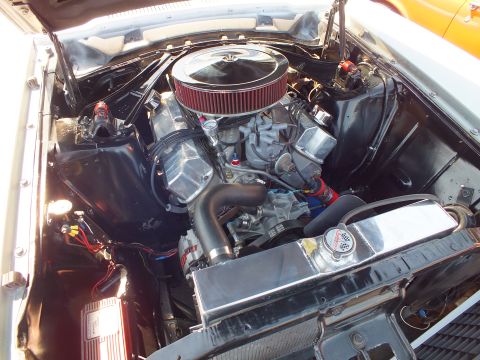 2003 Ford Crown Victoria - polished chrome V8 engine fitted with a large round air cleaner and chrome valve covers sits in a white car's black engine bay.