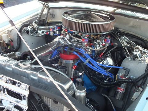 2003 Ford Crown Victoria - heavily detailed chrome V8 engine with a large round air cleaner, blue spark-plug wires and a red MSD ignition box fills the bay.