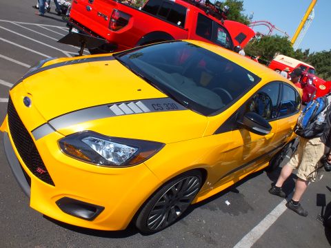 2003 Ford Crown Victoria - Front three-quarter view of a yellow Ford Focus ST with gray hood stripes and CS 330 graphics among show vehicles.
