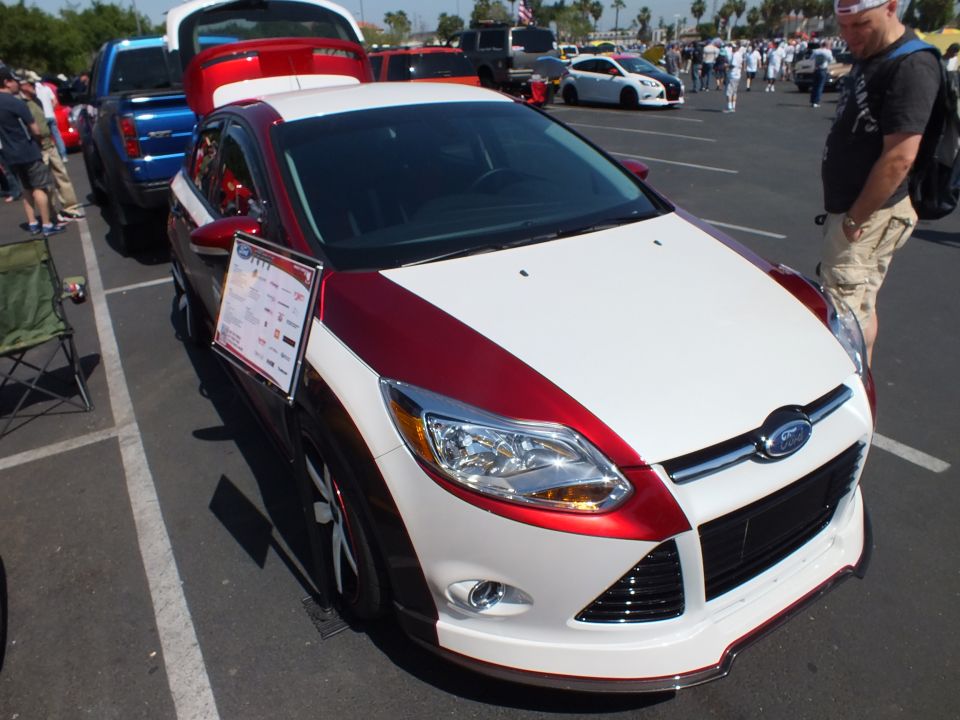 Red and white two-tone Ford Focus with show placard