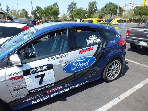 2003 Ford Crown Victoria - Close side view of a blue Ford Focus race car door showing number 7, a Ford oval, signatures, and Rally Innovations and Colin McRae decals.