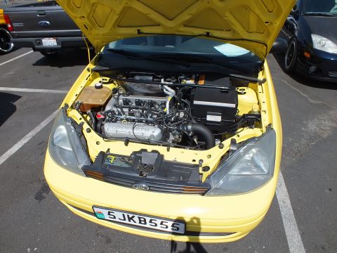 2003 Ford Crown Victoria - Front view of a yellow Ford with the hood up showing the engine bay and a California license plate reading 5JKB555.