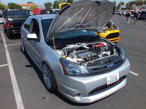 2003 Ford Crown Victoria - silver Ford Focus sedan displayed with its hood up, revealing the engine bay, with a California plate reading 4X108.