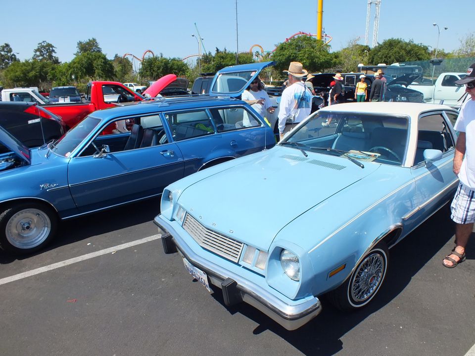 Light blue Ford Pinto and a blue Pinto wagon parked at a car show