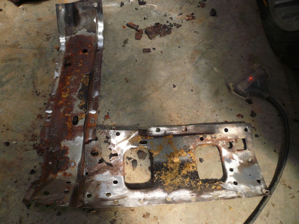 Rusted metal part with holes and Supermotors.net logo