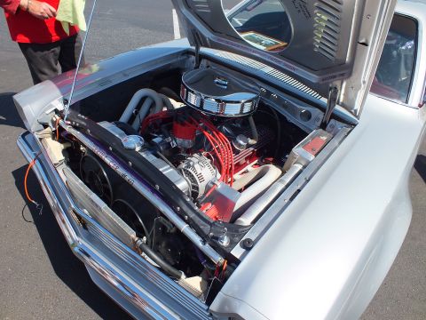 2003 Ford Crown Victoria - close-up of a custom engine bay shows a chromed V8 with a round air cleaner, red plug wires and polished accessories.