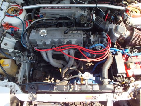 2003 Ford Crown Victoria - Detailed view of a Ford 2.2L fuel-injected 16-valve four-cylinder engine fitted with red ignition wires and a cone filter.