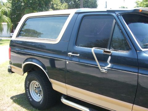 1991 Ford Bronco - This Ford Bronco is shown from the side, its two-tone paint scheme and removable top.