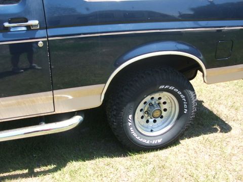 1991 Ford Bronco - Side view of a 1991 Ford Bronco, its dark blue paint, tan lower trim, and BFGoodrich All-Terrain tires.