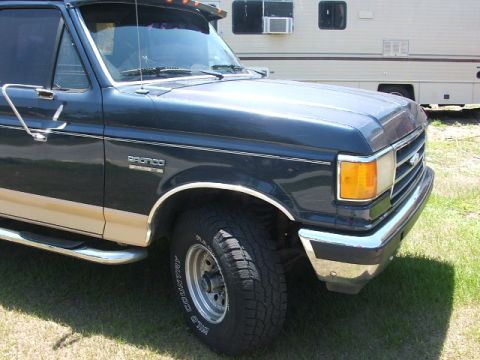 1991 Ford Bronco - Front 3/4 view of a 1991 Ford Bronco parked outdoors.