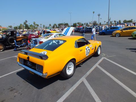 Yellow Ford Mustang fastback Trans-Am race car #15 with blue stripe, rear quarter view