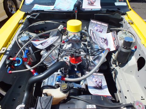 Detailed V8 engine bay with carburetor marked 5.0L