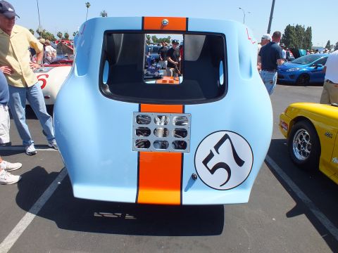 Rear of light blue and orange race car numbered 57