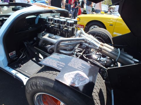 V8 with eight velocity stacks and headers in race car rear