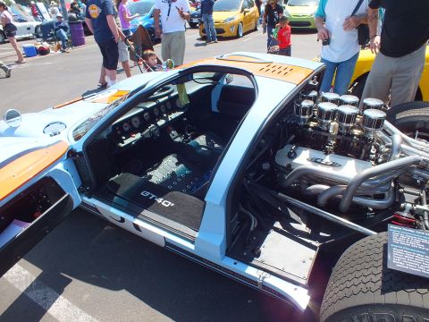 Light blue GT40 with doors and rear open at car show