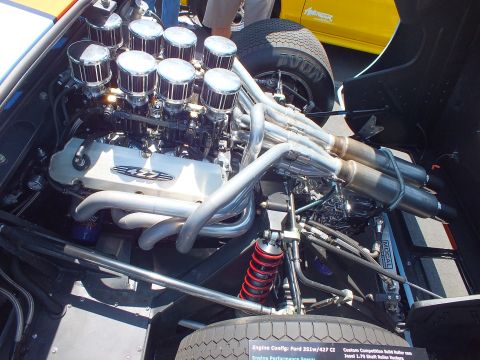 V8 engine with eight velocity stacks, 427 valve cover, spec card