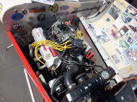 V8 engine with carburetor and yellow plug wires in hot rod