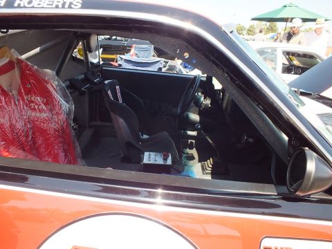 Stripped race interior with single seat and roll cage