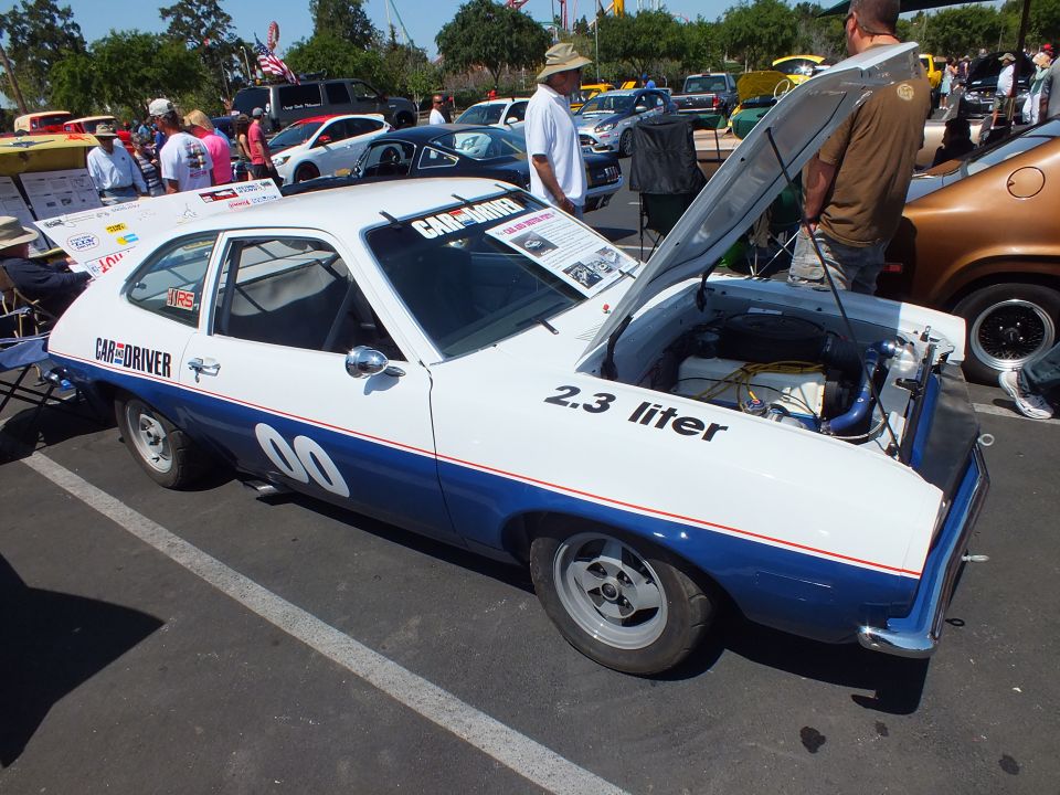 White and blue hatchback race car number 00 with Car and Driver and 2.3 liter lettering
