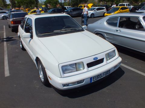 White Ford hatchback sedan with blue oval badge and EURO-FORD front plate at a car show