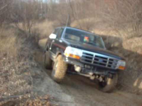 1993 Ford Bronco - 1993 Ford Bronco navigating an off-road trail.