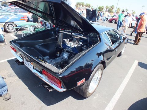 Black De Tomaso Pantera with open rear hood showing engine at show