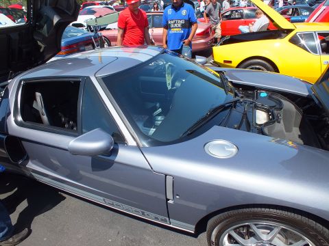 Silver Ford GT side and roof view at crowded car show, yellow car behind