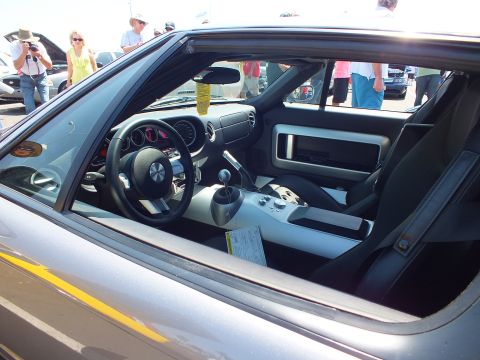 Silver Ford GT cockpit through window with gauges, shifter and show tag