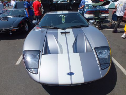 Silver Ford GT front with white stripes and Ford oval badge at car show
