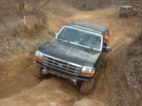 1993 Ford Bronco - Ford Bronco navigates a steep dirt path during an off-road excursion.