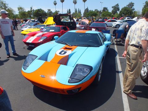 Light blue and orange Gulf-livery Ford GT at a busy outdoor car show