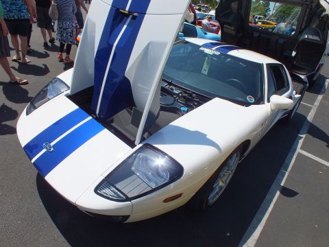 White Ford GT with blue stripes and open door and hatch at a show