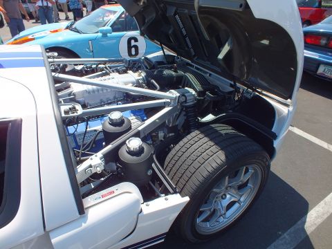 Rear engine bay of a white Ford GT with supercharged V8 and number 6