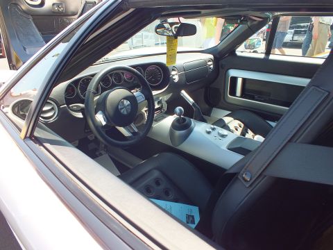 Interior of a sports car with round gauges and manual shifter