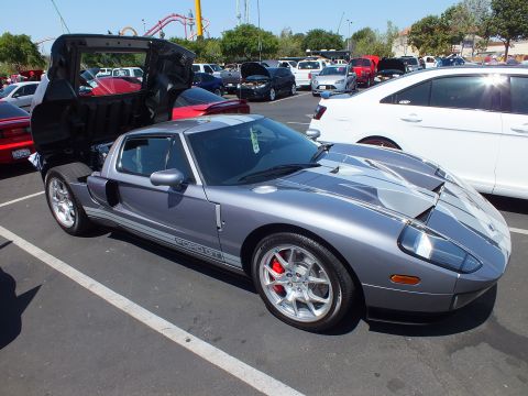 Silver Ford GT supercar with rear clamshell open in a parking lot