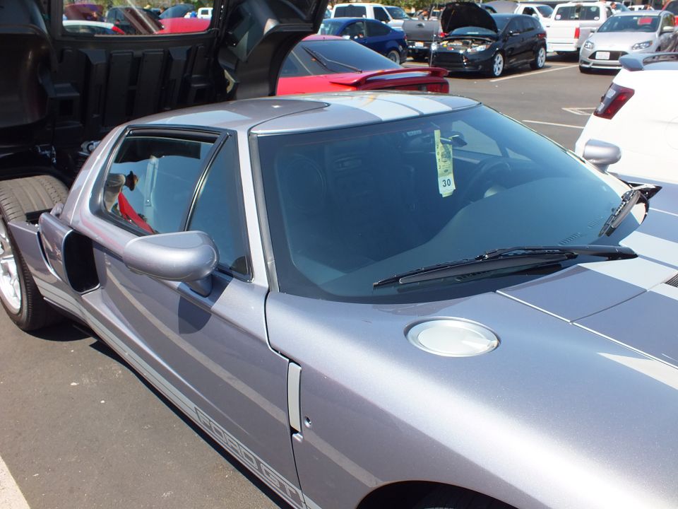 Front quarter of a silver-purple Ford GT showing windshield and side mirror