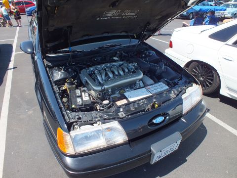 Front engine bay of a Ford Taurus SHO with SHO labeled hood underside