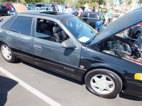 Dark green Ford Taurus SHO hatchback-style sedan with hood open