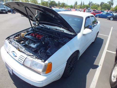 White Ford Taurus SHO sedan with hood up showing red-runner V6