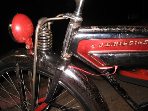 1994 Ford Bronco - Close-up of a vintage bicycle's front end, a red headlight and the J.C. Higgins brand name on its frame.