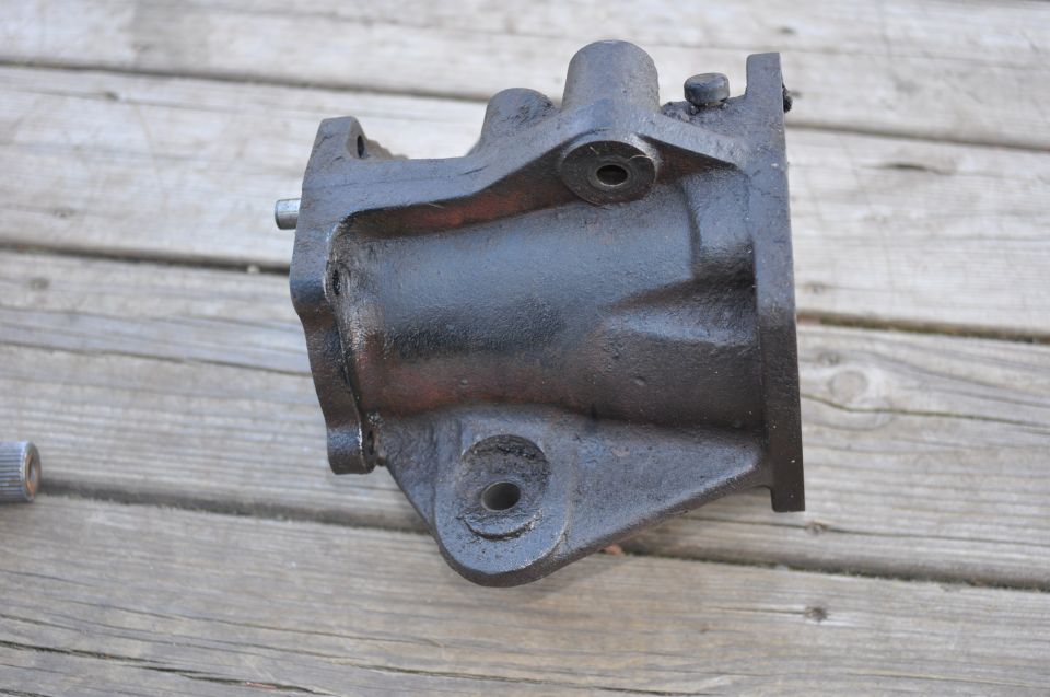 black metal steering gear box on wooden planks