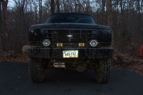 1996 Ford Bronco - This lifted Ford truck, likely from the mid-90s, is covered in mud and ready for off-road adventures.