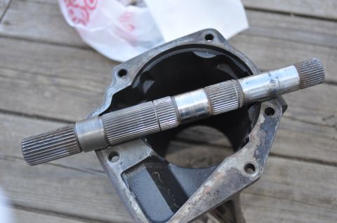 1974 Ford Bronco - Close-up of a driveshaft and its housing, components of a vehicle's drivetrain.