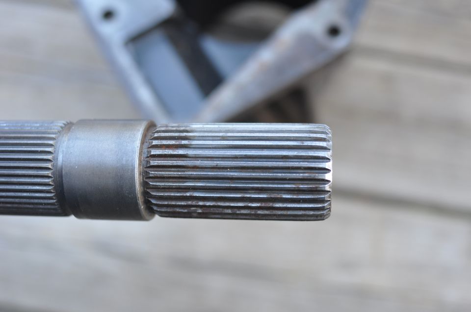 Driveshaft spline with a metal collar, close-up view
