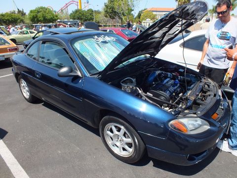Dark blue Ford Escort ZX2 coupe with hood open at car show