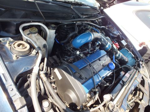 Engine bay with blue Ford Zetec valve cover and blue intake hose
