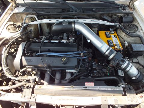 Engine bay with Ford VCT engine, silver intake, and strut tower bar