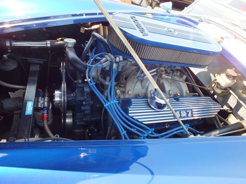 Engine bay with chrome oval air cleaner, 427 valve cover and blue plug wires