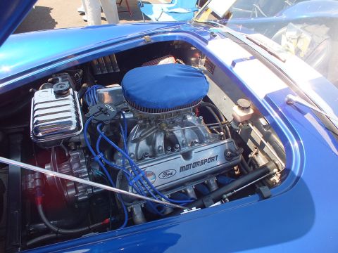 Engine bay with blue-covered air cleaner and Ford Motorsport valve cover, blue plug wires